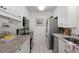 Well-lit kitchen with modern appliances, granite counters, and ample storage at 5681 Midnight Pass Rd # 104, Sarasota, FL 34242