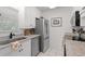 Updated kitchen features stainless steel appliances, granite countertops, and white cabinets at 5681 Midnight Pass Rd # 104, Sarasota, FL 34242