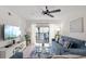 Bright living room with a balcony, modern furnishings, and a view of outdoor greenery at 5681 Midnight Pass Rd # 104, Sarasota, FL 34242