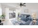 Bright living room with balcony access, stylish decor, and a comfortable seating arrangement at 5681 Midnight Pass Rd # 104, Sarasota, FL 34242