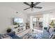 Well-lit living room with a balcony view, entertainment center, and comfortable seating at 5681 Midnight Pass Rd # 104, Sarasota, FL 34242