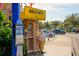 Quaint Mini Donuts stand with a large ice cream cone statue advertising coffee and sweets at 5681 Midnight Pass Rd # 104, Sarasota, FL 34242