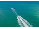 Open ocean view showing multiple boats speeding through turquoise water and creating large wakes at 5681 Midnight Pass Rd # 104, Sarasota, FL 34242