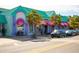 Vibrant shops with colorful awnings and displays in Siesta Key Village at 5681 Midnight Pass Rd # 104, Sarasota, FL 34242