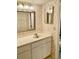 Cozy bathroom featuring a single sink vanity and framed mirror, complemented by patterned wallpaper at 6124 43Rd W St # 104A, Bradenton, FL 34210