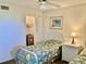 Charming bedroom with two twin beds, a nightstand, and artwork depicting beachside scenery at 6124 43Rd W St # 104A, Bradenton, FL 34210