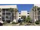 Inviting condominium building with well-maintained landscaping, palm trees, and convenient accessible parking in a desirable location at 6124 43Rd W St # 104A, Bradenton, FL 34210