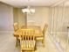 Bright dining room featuring tile floors and a classic chandelier, perfect for Gathering meals and entertaining guests at 6124 43Rd W St # 104A, Bradenton, FL 34210