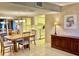 Open-concept dining area showcasing tile floors and seamless transition to the kitchen for easy meal service and entertaining at 6124 43Rd W St # 104A, Bradenton, FL 34210