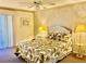 Sun-filled main bedroom with a large bed, side table, and lamp; decorated with beach-themed accents at 6124 43Rd W St # 104A, Bradenton, FL 34210