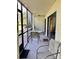 Relax on the covered lanai, featuring sliding glass doors and pleasant views of the surrounding landscape at 6124 43Rd W St # 104A, Bradenton, FL 34210