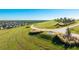 Green space with winding walking trails, a bench, and views of nearby residential areas at 6250 Grandview Hill Ct, Bradenton, FL 34203