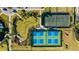 Aerial view of meticulously maintained tennis courts and lush green landscaping surrounding the community at 6250 Grandview Hill Ct, Bradenton, FL 34203