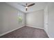 The bedroom offers a ceiling fan, natural light, and neutral decor for a relaxing atmosphere at 6250 Grandview Hill Ct, Bradenton, FL 34203