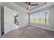 The bright bedroom boasts a ceiling fan, large window, and easy access to the lanai at 6250 Grandview Hill Ct, Bradenton, FL 34203