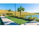 Beautifully maintained bocce ball court next to a tranquil pond in a well-manicured community at 6250 Grandview Hill Ct, Bradenton, FL 34203