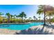 Stunning community pool area with lush landscaping and inviting cabanas at 6250 Grandview Hill Ct, Bradenton, FL 34203
