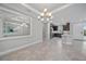 An open dining area offers mirrored walls for added light plus easy flow to the kitchen at 6250 Grandview Hill Ct, Bradenton, FL 34203