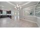Spacious dining area features a decorative chandelier and easy access to the modern kitchen at 6250 Grandview Hill Ct, Bradenton, FL 34203