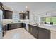 Modern kitchen with granite countertops, stainless steel appliances, and a view of the living room at 6250 Grandview Hill Ct, Bradenton, FL 34203