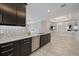 Modern kitchen features granite countertops, stainless steel appliances, and dark cabinets at 6250 Grandview Hill Ct, Bradenton, FL 34203