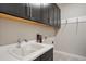 Laundry room features ample cabinet space, a utility sink, and a convenient coat rack at 6250 Grandview Hill Ct, Bradenton, FL 34203