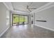Bright living room featuring tile flooring, a tray ceiling, and sliding doors to the outdoor area at 6250 Grandview Hill Ct, Bradenton, FL 34203