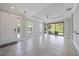 Bright and open living room with tile floors, tray ceiling, and access to the outdoor patio at 6250 Grandview Hill Ct, Bradenton, FL 34203