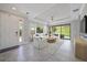 Bright living room with tile floors, a ceiling fan, and sliding glass doors to a green outdoor view at 6250 Grandview Hill Ct, Bradenton, FL 34203