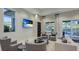 Comfortable lounge area with plush seating, a mounted TV, and view of the outdoor amenities at 6250 Grandview Hill Ct, Bradenton, FL 34203