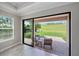 Sliding glass doors open from a room to a patio with relaxing outdoor seating at 6250 Grandview Hill Ct, Bradenton, FL 34203