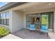 Cozy covered patio with brick pavers, stylish seating, and seamless indoor-outdoor flow at 6250 Grandview Hill Ct, Bradenton, FL 34203