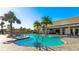 Inviting community pool with sun loungers and lush tropical landscaping at 6250 Grandview Hill Ct, Bradenton, FL 34203