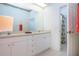 Bright bathroom featuring double sink vanity, and doorway to adjacent room at 6307 Laurel Creek Trl, Ellenton, FL 34222