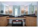 Bright bathroom with vanity featuring mirrors, towels, and decorative soap and flowers at 6307 Laurel Creek Trl, Ellenton, FL 34222