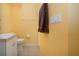 Bathroom with a tile floor, toilet, sink and towel rack with a brown towel hanging at 6307 Laurel Creek Trl, Ellenton, FL 34222
