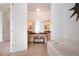 Bathroom with soaking tub, large vanity with mirrors, and access to the main bedroom at 6307 Laurel Creek Trl, Ellenton, FL 34222