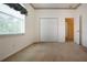 Bedroom with an opened window and an open door to an adjacent space at 6307 Laurel Creek Trl, Ellenton, FL 34222