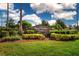 A manicured community entrance sign with a rock wall and shrubbery at 6307 Laurel Creek Trl, Ellenton, FL 34222