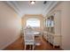 Dining area features a table set with chairs, cabinet and natural light at 6307 Laurel Creek Trl, Ellenton, FL 34222