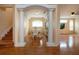 Dining area with decorative columns and a view to living room at 6307 Laurel Creek Trl, Ellenton, FL 34222