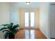 Bright and airy entryway with hardwood floors and natural light streaming in at 6307 Laurel Creek Trl, Ellenton, FL 34222