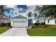 Inviting two-story home boasting a well-manicured lawn and charming architectural details at 6307 Laurel Creek Trl, Ellenton, FL 34222