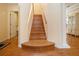Entryway with hardwood floors, staircase leading upstairs, and a glimpse into the adjacent rooms at 6307 Laurel Creek Trl, Ellenton, FL 34222