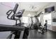 Bright community gym with modern equipment, including elliptical, weight machines, and mounted TV at 6307 Laurel Creek Trl, Ellenton, FL 34222
