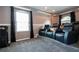 Home theater with comfortable seating, projector, and dark curtains at 6307 Laurel Creek Trl, Ellenton, FL 34222