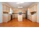 Kitchen with wood floors, island and stainless steel refrigerator and oven at 6307 Laurel Creek Trl, Ellenton, FL 34222