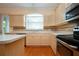 Well-lit kitchen features stainless steel appliances, lots of countertop space, and a center island at 6307 Laurel Creek Trl, Ellenton, FL 34222