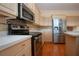 Kitchen with wood floors, stainless steel appliances and white countertops and cabinetry at 6307 Laurel Creek Trl, Ellenton, FL 34222