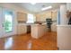 Bright kitchen features wood floors, stainless steel appliances, an island, and ample cabinet space at 6307 Laurel Creek Trl, Ellenton, FL 34222